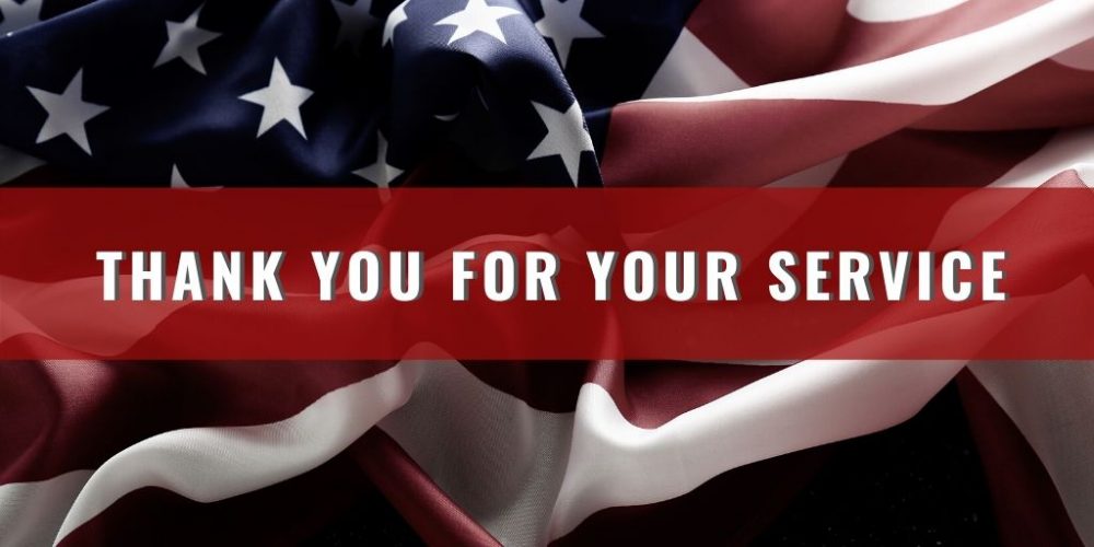 A photo of an American flag with text running across it that reads,"THANK YOU FOR YOUR SERVICE"