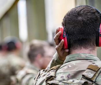 An Airman from the 423d Security Forces Squadron adjusts his ear protection during a proficiency course at RAF Molesworth, England, Aug. 19, 2022. During the course instructors from the 820th Base Defense Group and 435th Contingency Response Group provided oversight and guidance to help critique and advance the combat arms skills of the defenders from the 423d SFS. (U.S. Air Force photo by Staff Sgt. Eugene Oliver)